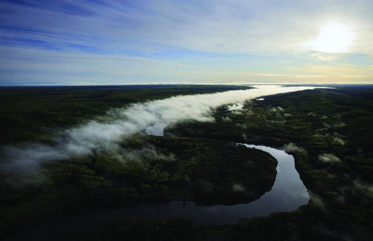 Ground fog over the river Athabasca and boreal forest in early morning, north of Fort McMurray, northern Alberta, Canada.